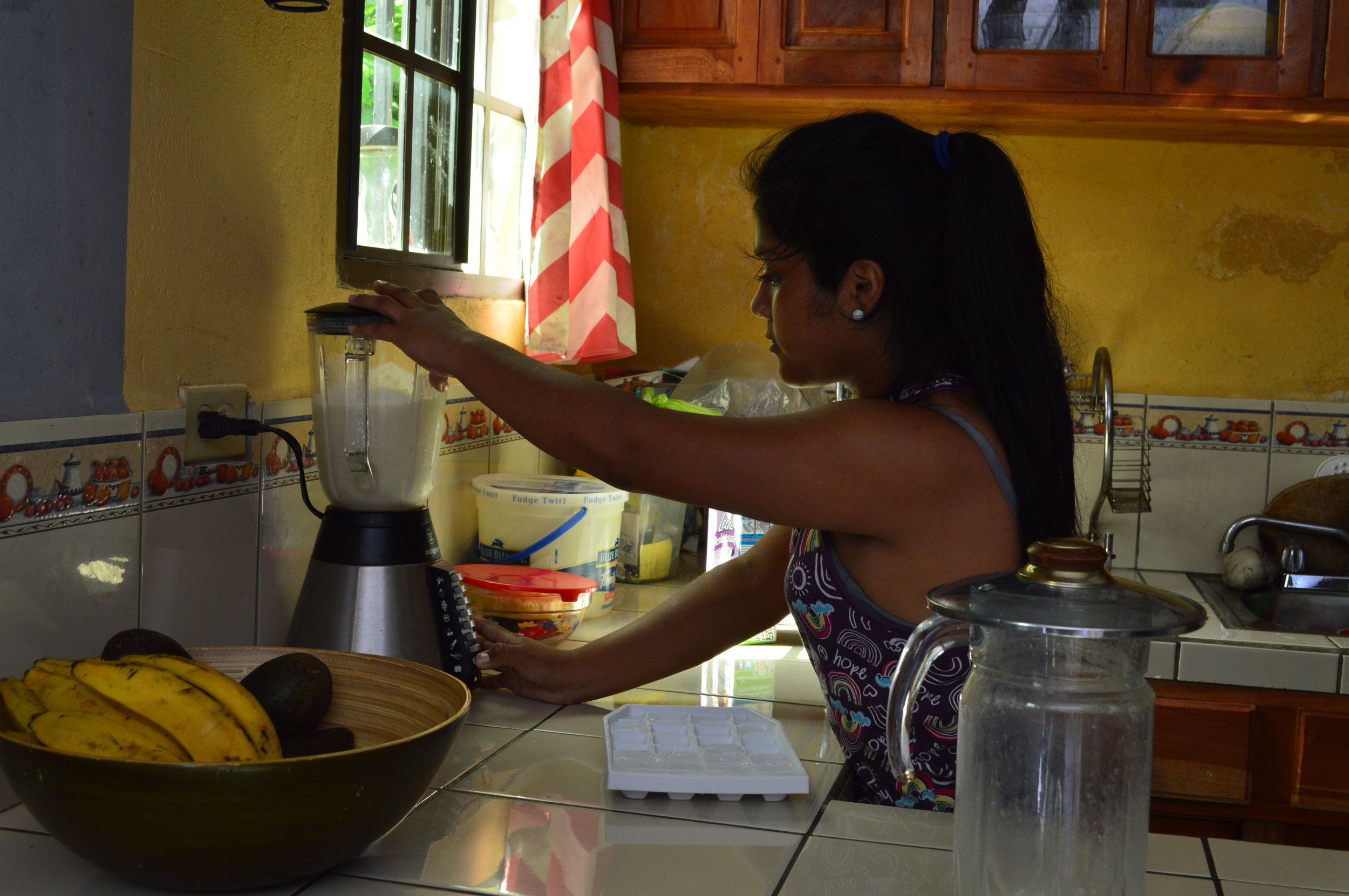 My host making a banana milkshake 