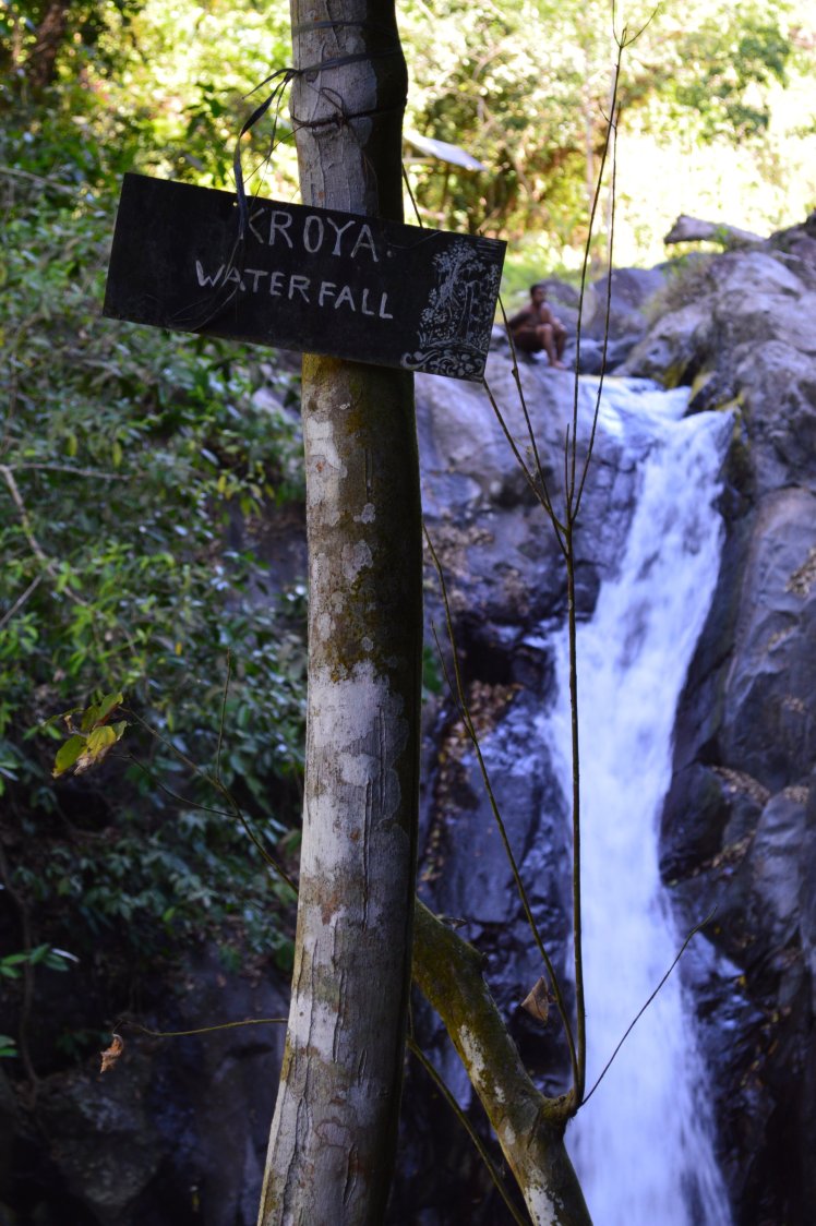 A guide sitting atop the Kroya waterfall where you can slide down