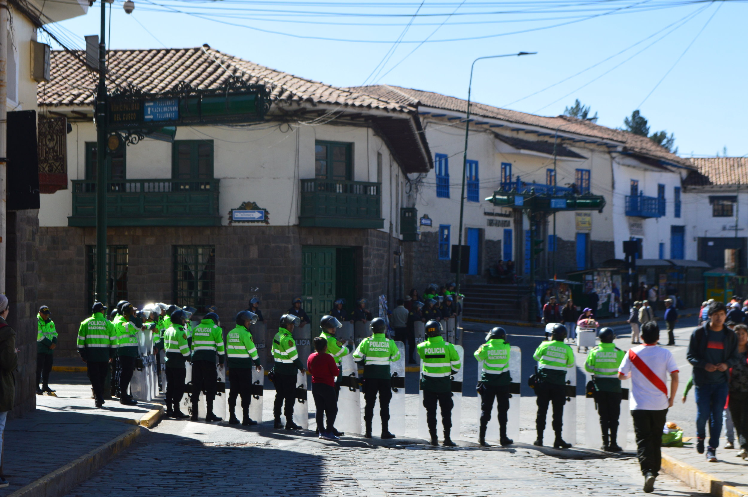 Local and riot police standing guard around town