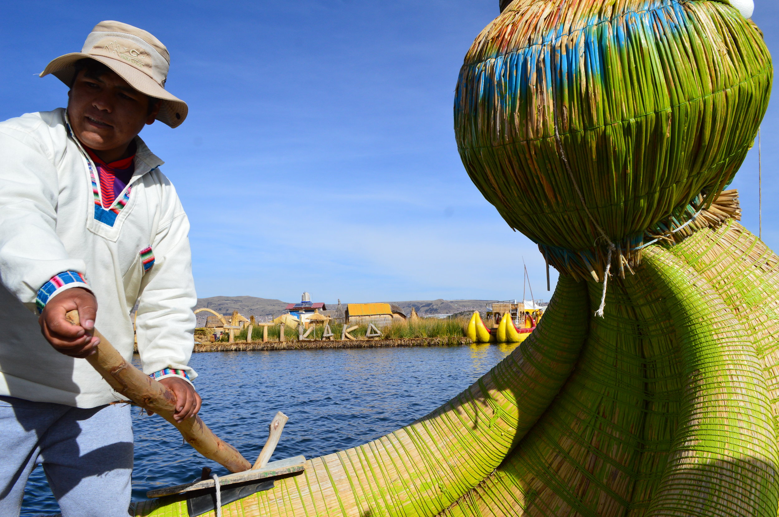 The president of one of the floating islands rowing this traditional boat